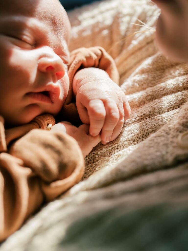 Close up of newborn baby's face and the sunlight highlighting his sweet features