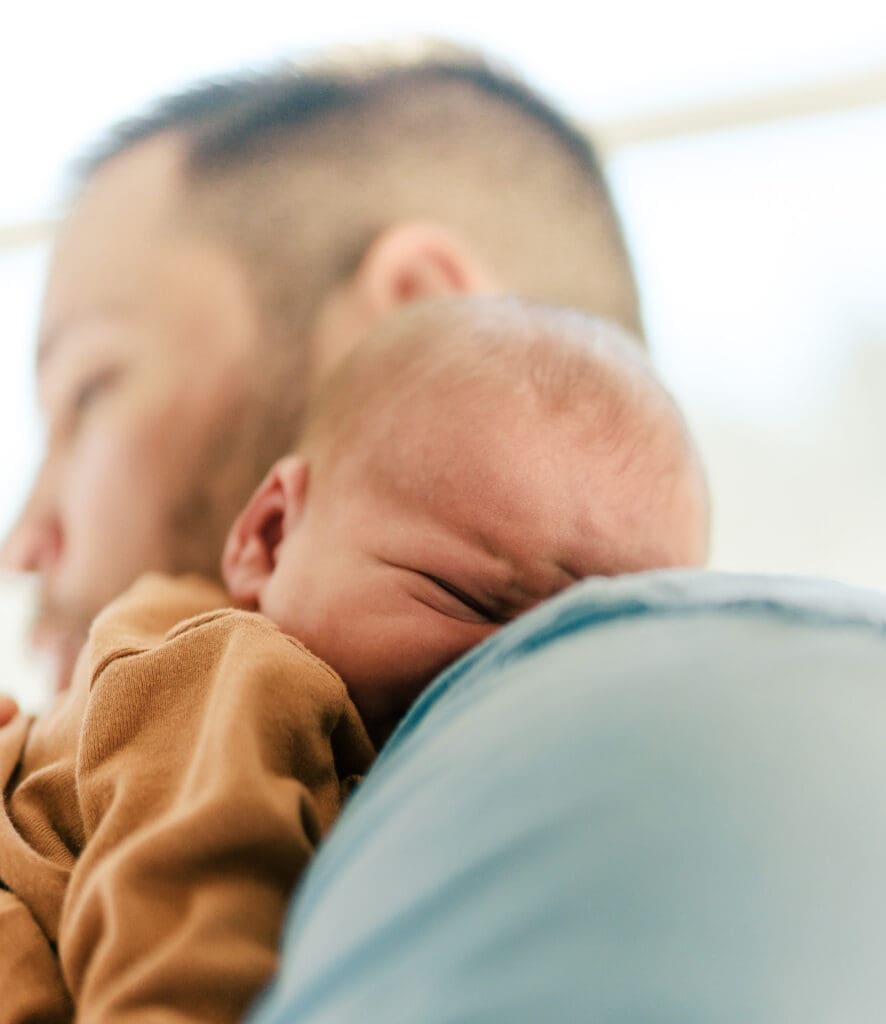 Close up of baby on dad's shoulder.