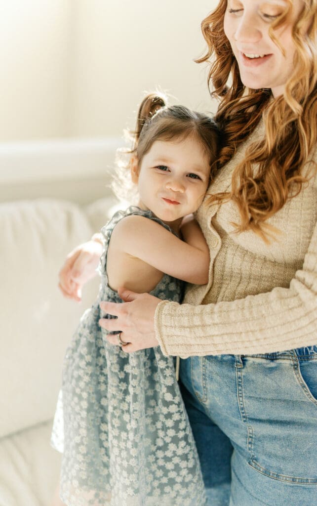 Mother and little sister embracing